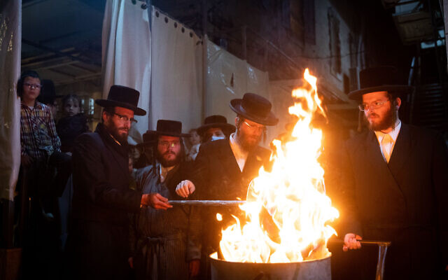 Ultra-Orthodox Jews celebrate the Jewish holiday of Lag Baomer in the ultra-Orthodox neighborhood of Mea Shearim in Jerusalem on May 11, 2020. (Yonatan Sindel/Flash90)