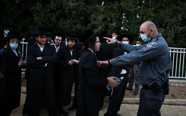Ultra-Orthodox men clash with police officers during the celebrations of the Jewish holiday of Lag B'Omer on Mount Meron in northern Israel on May 12, 2020. (David Cohen/Flash90) Ultra-Orthodox men clash with police officers during the celebrations of the Jewish holiday of Lag B'Omer on Mount Meron in northern Israel on May 12, 2020. (David Cohen/Flash90)