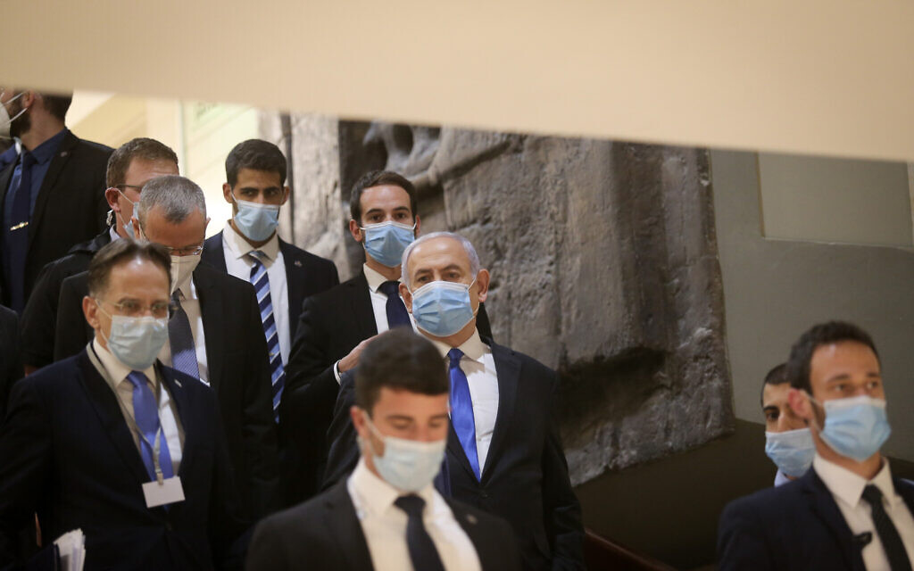 Prime Minister Benjamin Netanyahu walks into the Knesset after presenting the 35th government of Israel to the Knesset, May 17, 2020. (Alex Kolomoisky/POOL)