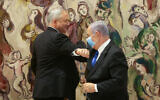 Prime Minister Benjamin Netanyahu (right) and Blue and White party leader Benny Gantz at the Knesset, May 17, 2020, after the new government was sworn in. (Alex Kolomoisky/POOL)