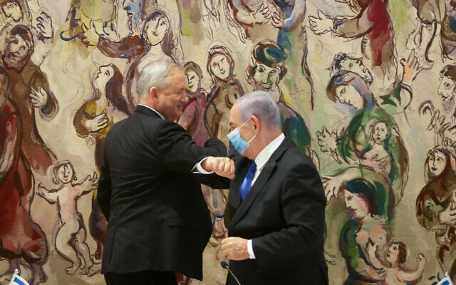 Prime Minister Benjamin Netanyahu (right) and Blue and White party leader Benny Gantz at the Knesset, May 17, 2020, after the new government was sworn in. (Alex Kolomoisky/POOL) Prime Minister Benjamin Netanyahu (right) and Blue and White party leader Benny Gantz at the Knesset, May 17, 2020, after the new government was sworn in. (Alex Kolomoisky/POOL)