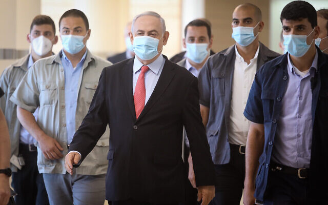 Prime Minister Benjamin Netanyahu, center, arrives for a Likud faction meeting at the Knesset, May 25, 2020. (Flash90) Prime Minister Benjamin Netanyahu, center, arrives for a Likud faction meeting at the Knesset, May 25, 2020. (Flash90)