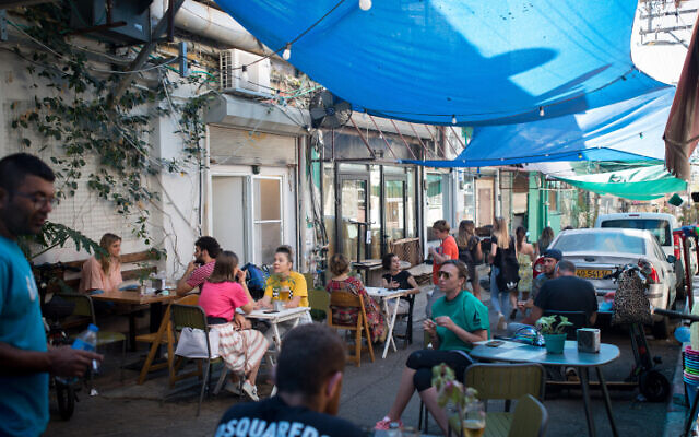 People sitting at a restaurant at the Carmel market in Tel Aviv on May 26, 2020. (Miriam Alster/FLASH90) People sitting at a restaurant at the Carmel market in Tel Aviv on May 26, 2020. (Miriam Alster/FLASH90)