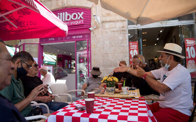 Customers sit at a Coffee Shop in Jerusalem after it was reopened on May 27, 2020. (Yonatan Sindel/Flash90)