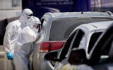 Magen David Adom medical workers at a drive-through site to collect samples for coronavirus testing in Jerusalem on May 30, 2020 (Yonatan Sindel/Flash90)