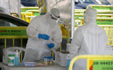 Magen David Adom medical workers collect samples for coronavirus testing in Jerusalem on May 31, 2020. (Olivier Fitoussi/Flash90)