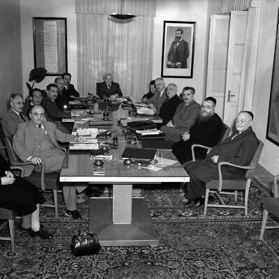 Israel's First Government, photographed on May 1, 1949. Left to right: Golda Meir, Zalman Shazar, Bechor-Shalom Sheetrit, Zvi Maimon (cabinet stenographer), Dov Yosef, Eliezer Kaplan, Moshe Sharett, Prime Minister David Ben-Gurion, Ze'ev Sherf (cabinet secretary), Pinchas Rosen, David Remez, Haim Moshe Shapira, Yitzhak Meir Levin, Yehuda Leib Maimon. (Hugo Mendelson/National Photo Collection of Israel/GPO/Wikipedia/Public domain)
