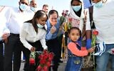 In this photo from the Jewish Agency, Immigration Minister Pnina Tamano-Shata (left) and then-Jewish Agency Chairman Isaac Herzog (center) greet 119 new immigrants from Ethiopia at Ben Gurion Airport, May 21, 2020. (Shlomi Amsalem)