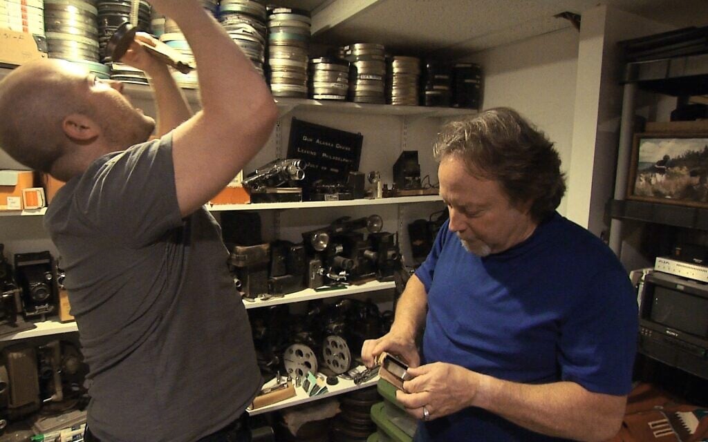 Sasha Joseph Neulinger (left) and his father Henry Nevison looking through old home movie footage. (Step 1 Films)