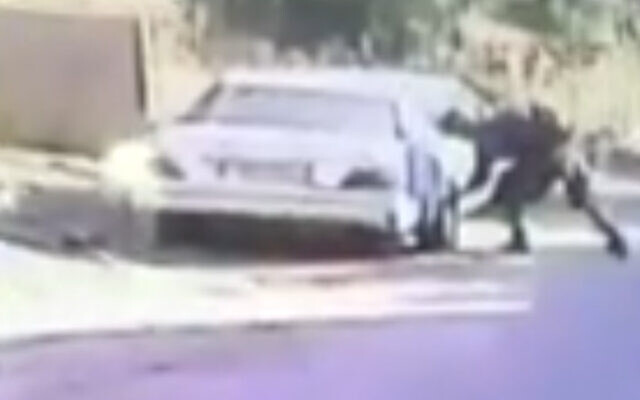 An Israeli soldier appears to slash the tires of a Palestinian limousine in Kafr Qaddum during a violent demonstration in the northern West Bank village on May 30, 2020. (Screen capture: B'Tselem) An Israeli soldier appears to slash the tires of a Palestinian limousine in Kafr Qaddum during a violent demonstration in the northern West Bank village on May 30, 2020. (Screen capture: B'Tselem)
