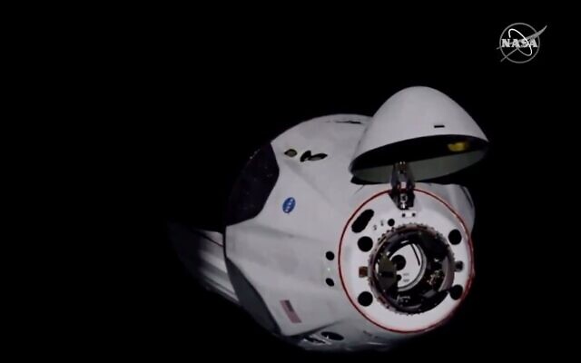 Screen capture from video of the SpaceX Dragon crew capsule, with NASA astronauts Doug Hurley and Robert Behnken aboard, as it docks with the International Space Station, May 31, 2020. (NASA TV via AP) Screen capture from video of the SpaceX Dragon crew capsule, with NASA astronauts Doug Hurley and Robert Behnken aboard, as it docks with the International Space Station, May 31, 2020. (NASA TV via AP)