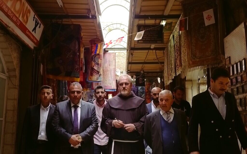 Keeper of the key Adeeb Joudeh al-Husseini (front row left) and gatekeeper Wajeeh Nuseibeh (front row second from right) on their way to open the Church of the Holy Sepulchre on Easter. (Yoram Millo)