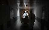 Medical workers move a coronavirus patient at an intensive care unit of the Filatov City Clinical Hospital in Moscow, Russia, May 15, 2020. (AP/Pavel Golovkin)