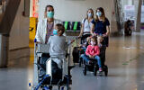 Wives and children of German business people working in China walk through a terminal at the airport in Frankfurt, Germany, May 29, 2020. (AP/Michael Probst)