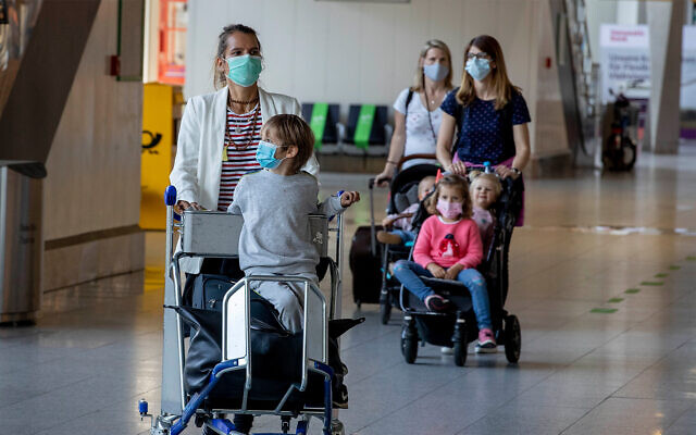 Wives and children of German business people working in China walk through a terminal at the airport in Frankfurt, Germany, May 29, 2020. (AP/Michael Probst) Wives and children of German business people working in China walk through a terminal at the airport in Frankfurt, Germany, May 29, 2020. (AP/Michael Probst)