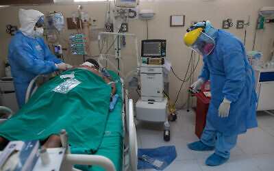 Doctors tend to a patient inside the intensive care unit for people infected with the coronavirus at a public hospital in Lima, Peru, April 30, 2020. (AP/Rodrigo Abd)