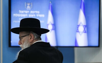 Then-health minister Yaakov Litzman attends a press conference about the coronavirus at the Prime Minister's Office in Jerusalem, March 25, 2020. (Olivier Fitoussi/Flash90) Then-health minister Yaakov Litzman attends a press conference about the coronavirus at the Prime Minister's Office in Jerusalem, March 25, 2020. (Olivier Fitoussi/Flash90)