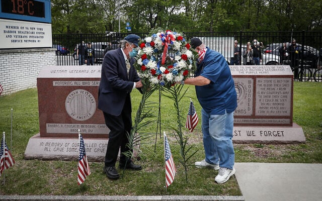 A motorcade of veterans stops outside the VA Medical Center as wreaths are placed beside memorial stones on the premises in Brooklyn, New York, May 25, 2020. (AP/John Minchillo) A motorcade of veterans stops outside the VA Medical Center as wreaths are placed beside memorial stones on the premises in Brooklyn, New York, May 25, 2020. (AP/John Minchillo)