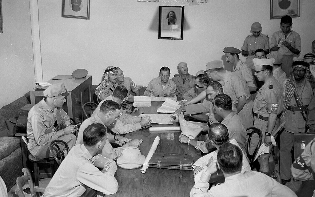 UN personnel and representatives of Israel, Trans-Jordan and Egypt pore over a map of Jerusalem at the residence of the Syrian Catholic archbishop near Damascus Gate, Jerusalem, August 22, 1948. Moshe Dayan is seated, wearing an eye patch. (AP/Jim Pringle)