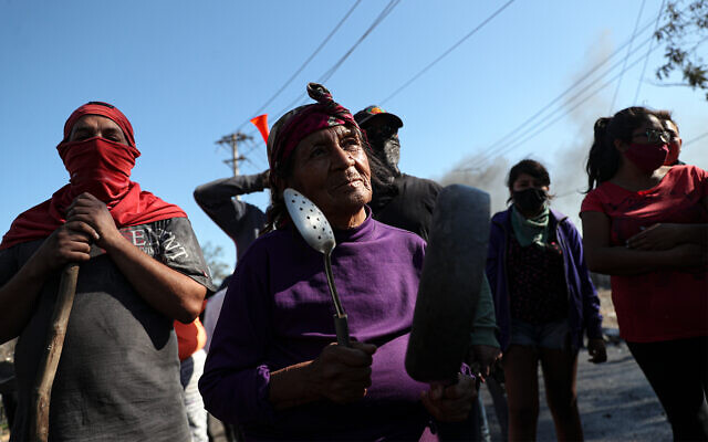 Demonstrators gather near a burning barricade during a protest demanding food aid in Santiago, Chile, May 26, 2020. (AP/Esteban Felix) Demonstrators gather near a burning barricade during a protest demanding food aid in Santiago, Chile, May 26, 2020. (AP/Esteban Felix)