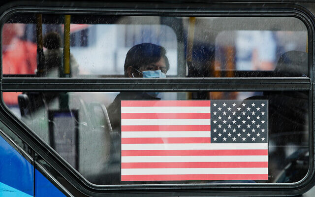 A bus passenger watches people line up for a mobile food pantry at Barclays Center in Brooklyn, New York, April 24, 2020. (AP/Frank Franklin II) A bus passenger watches people line up for a mobile food pantry at Barclays Center in Brooklyn, New York, April 24, 2020. (AP/Frank Franklin II)