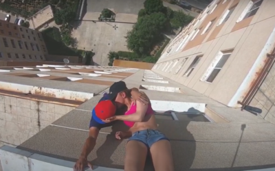 Iranian parkour athlete Alireza Japalaghy (L) kissing a woman on a rooftop in Tehran, May 2020. (Screenshot: YouTube)
