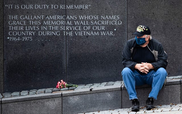 Vietnam Veteran Kitch Kichula, wearing a protective face mask as a precaution against the coronavirus, pays his respects at the at the Vietnam War Memorial on Memorial Day in Philadelphia, Pennsylvania, May 25, 2020. (AP/Matt Rourke) Vietnam Veteran Kitch Kichula, wearing a protective face mask as a precaution against the coronavirus, pays his respects at the at the Vietnam War Memorial on Memorial Day in Philadelphia, Pennsylvania, May 25, 2020. (AP/Matt Rourke)
