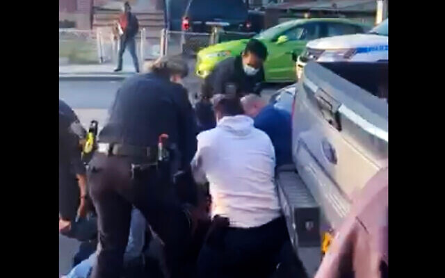 New York City police officers wrestle a man to the ground while making an arrest in the Brooklyn borough of New York, April 29, 2020. (Adegoke Atunbi via AP) New York City police officers wrestle a man to the ground while making an arrest in the Brooklyn borough of New York, April 29, 2020. (Adegoke Atunbi via AP)