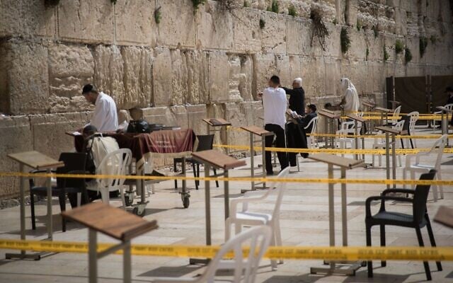 Worshipers at the Western Wall pray in enclosed areas meant for 10 people at a time in order to prevent the spread of coronavirus on March 15, 2020 (Yonatan Sindel/Flash90) Worshipers at the Western Wall pray in enclosed areas meant for 10 people at a time in order to prevent the spread of coronavirus on March 15, 2020 (Yonatan Sindel/Flash90)