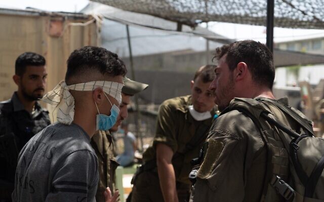 Israeli troops interrogate a Palestinian man as part of a manhunt for the person who threw a brick at Sgt. First Class Amit Ben-Ygal, killing him, in the West Bank village of Yabed on May 13, 2020. (Israel Defense Forces) Israeli troops interrogate a Palestinian man as part of a manhunt for the person who threw a brick at Sgt. First Class Amit Ben-Ygal, killing him, in the West Bank village of Yabed on May 13, 2020. (Israel Defense Forces)