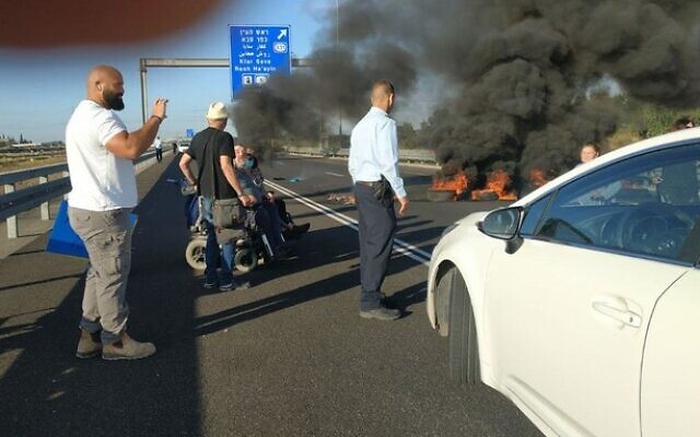 Activists block the Ayalon Highway near Tel Aviv on May 31, 2020, demanding increased stipends for people with disabilities. (Lavi Naor/courtesy) Activists block the Ayalon Highway near Tel Aviv on May 31, 2020, demanding increased stipends for people with disabilities. (Lavi Naor/courtesy)