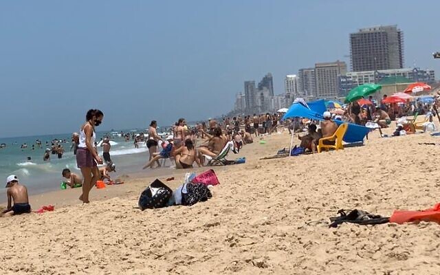 Crowds on the beach at Rishon Lezion, May 16, 2020 (ToI staff) Crowds on the beach at Rishon Lezion, May 16, 2020 (ToI staff)