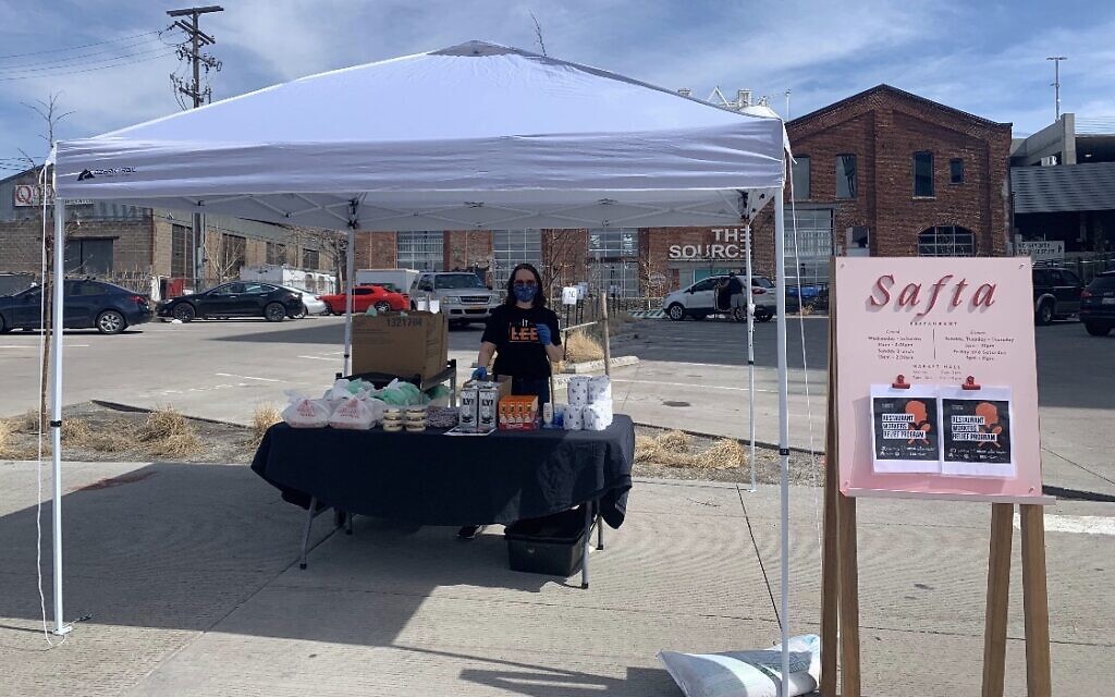 Workers at Alon Shaya's Denver restaurant Safta set up a table outside with food for laid-off or furloughed restaurant workers to pick up. (Courtesy Pomegranate Hospitality)