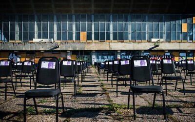 Chairs with fake money notes standing next to the decaying Palace of Concerts and Sports of Vilnius, Lithuania, on May 1, 2020. (Courtesy of the display's organizers, via JTA) Chairs with fake money notes standing next to the decaying Palace of Concerts and Sports of Vilnius, Lithuania, on May 1, 2020. (Courtesy of the display's organizers, via JTA)