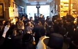 Dozens gather when police arrive to disperse a gathering in contravention of coronavirus regulations at synagogue in Jerusalem ultra-Orthodox neighborhood of Mea She'arim, May 15, 2020 (Screen grab/Kan)