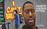 A woman wearing a protective mask walks past graffiti in Berlin's Mauer Park depicting George Floyd, a black man who died in Minneapolis after a white policeman kneeled on his neck for several minutes. (Photo by Odd ANDERSEN / AFP)