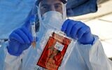 Israeli medical personnel take samples at a drive-thru COVID-19 testing facility in Ramat Hasharon near Tel Aviv, on June 1, 2020. (Jack Guez/AFP)