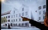 A man points his finger at a screen showing the planned architectural redesign of the house Adolf Hitler was born in, during a press conference at the interior ministry in Vienna, June 2, 2020. (Joe Klamar/AFP/File)