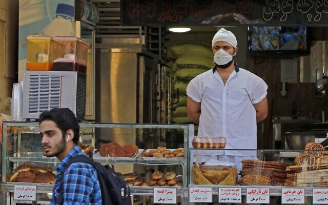 An Iranian man walks in front of a pastry shop in the capital Tehran on June 3, 2020, amid the coronavirus pandemic. (AFP) An Iranian man walks in front of a pastry shop in the capital Tehran on June 3, 2020, amid the coronavirus pandemic. (AFP)