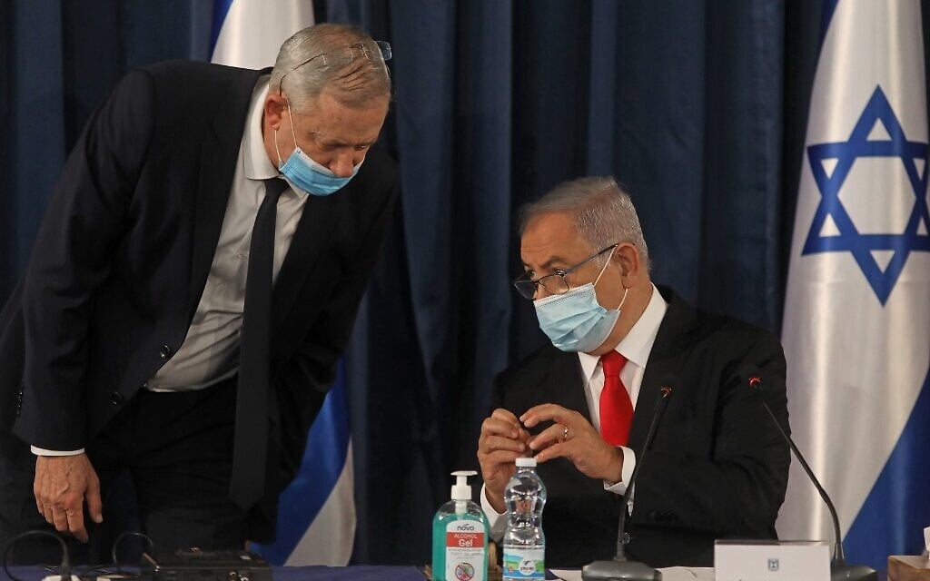 Prime Minister Benjamin Netanyahu (R) speaks with Alternate PM and Defense Minister Benny Gantz, both wearing protective mask due to the ongoing COVID-19 pandemic, during the weekly cabinet meeting in Jerusalem on June 7, 2020. (Menahem Kahana/AFP) Prime Minister Benjamin Netanyahu (R) speaks with Alternate PM and Defense Minister Benny Gantz, both wearing protective mask due to the ongoing COVID-19 pandemic, during the weekly cabinet meeting in Jerusalem on June 7, 2020. (Menahem Kahana/AFP)