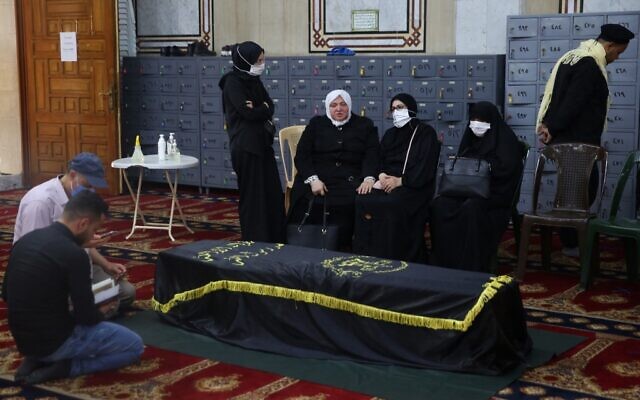 Mourners pray over the coffin of Ramadan Shalah, former leader of the Palestinian Islamic Jihad terror group, during his funeral in the Syrian capital Damascus on June 7, 2020. (AFP) Mourners pray over the coffin of Ramadan Shalah, former leader of the Palestinian Islamic Jihad terror group, during his funeral in the Syrian capital Damascus on June 7, 2020. (AFP)