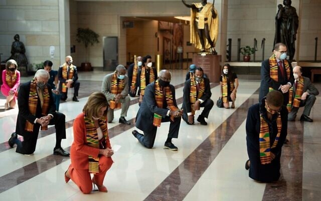 Democratic lawmakers take a knee to observe a moment of silence on Capitol Hill for George Floyd and other victims of police brutality June 8, 2020, in Washington. (Brendan Smialowski/AFP) Democratic lawmakers take a knee to observe a moment of silence on Capitol Hill for George Floyd and other victims of police brutality June 8, 2020, in Washington. (Brendan Smialowski/AFP)