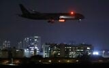 A cargo plane operated by Etihad Airways, carrying medical aid for Palestinians related to the coronavirus COVID-19 disease, prepares to land at Israel's Ben Gurion Airport near Tel Aviv on June 9, 2020. (Jack Guez/AFP)