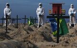 Activists from the Brazilian NGO Rio de Paz (Peace Rio), stand next to 100 mock graves on Copacabana beach symbolizing deaths from the COVID-19 coronavirus in Rio de Janeiro, Brazil, on June 11, 2020, to protest against Brazil's 'bad governance' of the pandemic (CARL DE SOUZA / AFP)