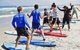 Hamama Jarban (R), 41, a lifeguard angler and surf teacher, gives surf lessons on June 12, 2020 on the beach in the coastal village of Jisr az-Zarqa (JACK GUEZ / AFP)