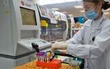 An Israeli laboratory worker conducts serological tests for coronavirus at the Leumit Health Care Services laboratory in Or Yehuda, near Tel Aviv on June 29, 2020. (Gil Cohen-Magen/AFP)