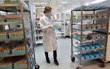 An Israeli laboratory worker is pictured as she checks serological tests at the Leumit Health Care Services laboratory in Or Yehuda, near Tel Aviv on June 29, 2020. (GIL COHEN-MAGEN / AFP)