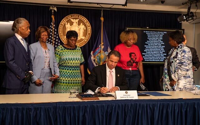 New York Governor Andrew Cuomo signs the 'Say Their Name' reform during the daily media briefing as he is joined by (L-R) Rev. Al Sharpton, Dr. Hazel N. Dukes, Valerie Bell; the mother of Sean Bell, Gwen Carr; the mother of Eric Garner, and NY State Sen. Andrea Stewart- Cousins at the Office of the Governor of the State of New York on June 12, 2020 in New York City. (Jeenah Moon/Getty Images/AFP) New York Governor Andrew Cuomo signs the 'Say Their Name' reform during the daily media briefing as he is joined by (L-R) Rev. Al Sharpton, Dr. Hazel N. Dukes, Valerie Bell; the mother of Sean Bell, Gwen Carr; the mother of Eric Garner, and NY State Sen. Andrea Stewart- Cousins at the Office of the Governor of the State of New York on June 12, 2020 in New York City. (Jeenah Moon/Getty Images/AFP)