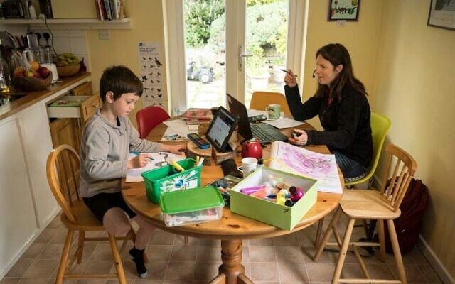 Illustrative: A mother home schools a child. (AFP Photo/OLI SCARFF) Illustrative: A mother home schools a child. (AFP Photo/OLI SCARFF)