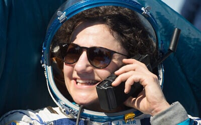 NASA astronaut Jessica Meir talks to her mother on a satellite phone outside the Soyuz MS-15 spacecraft after she lands with NASA astronaut Andrew Morgan and Roscosmos cosmonaut Oleg Skripochka in a remote area near the town of Zhezkazgan, Kazakhstan on April 17, 2020. (NASA/GCTC/Andrey Shelepin)